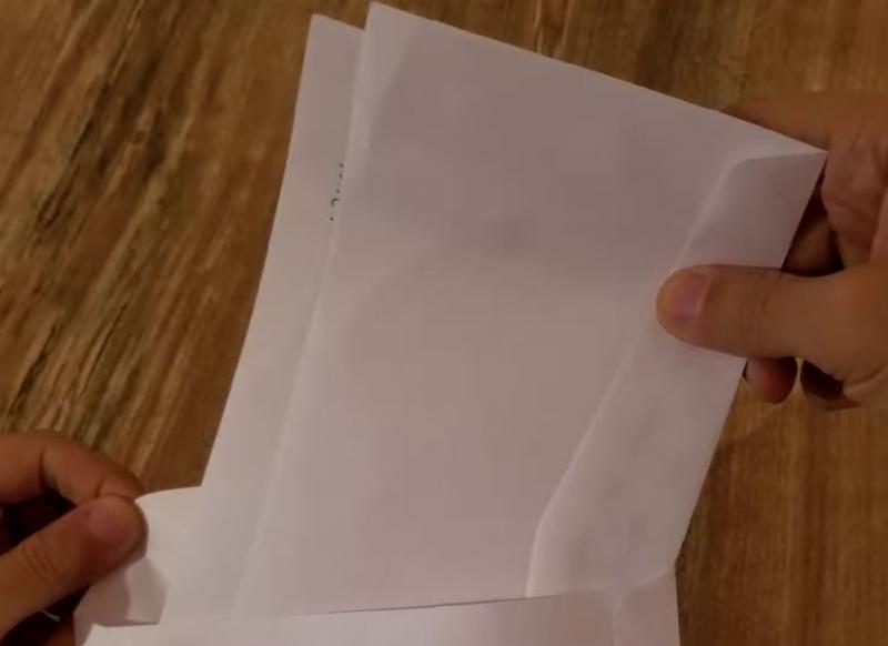 Two paper envelopes kept in a large paper envelope, with cotton swabs inside.